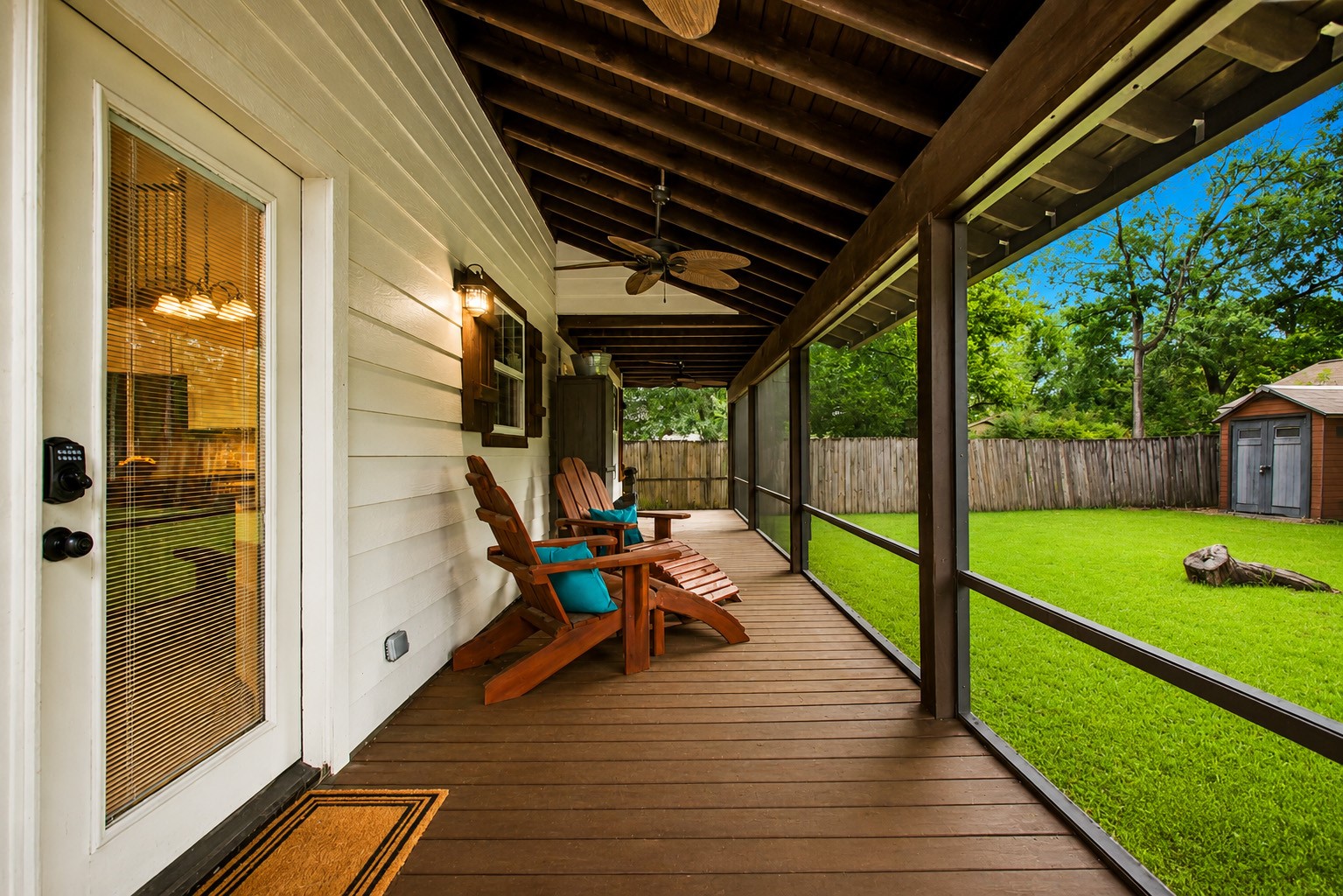 312 Springwood Drive Conroe, TX 77385 - Photo 41 of 50 The covered and screened in back patio offers peaceful views of the mature trees and expansive backyard.