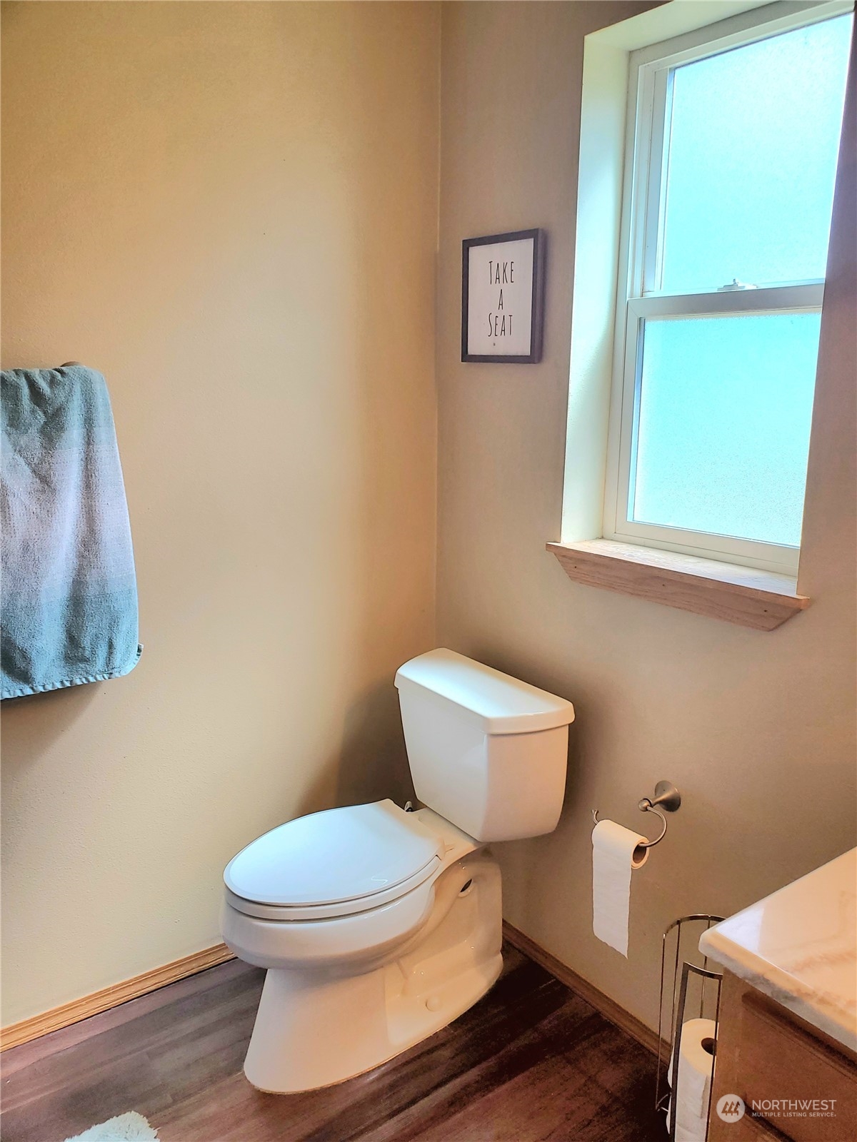 1241 North Sage Road Ritzville, WA 99169 - Photo 18 of 40 a white toilet sitting next to a bathroom sink and vanity