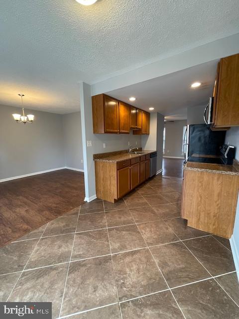 48 Fleming Street Newark, DE 19713 - Photo 2 of 16 a kitchen with granite countertop a rug a stove a microwave and counter space