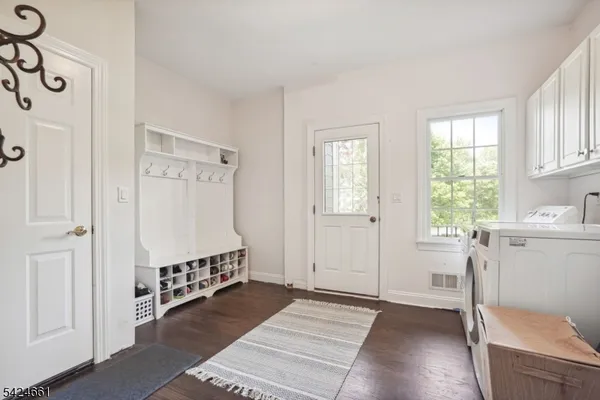 a room with a baby crib a fireplace and a window