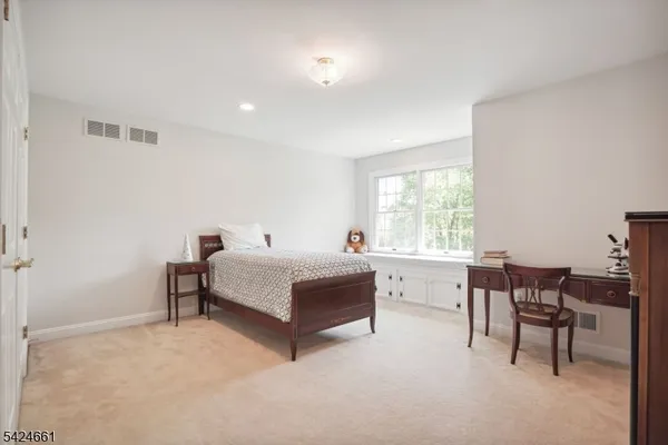 a spacious bedroom with a bed and a table in it