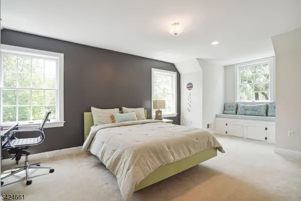 a spacious bedroom with a bed and a chair