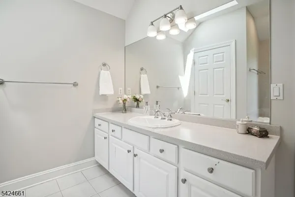 a bathroom with a granite countertop sink a toilet and a mirror