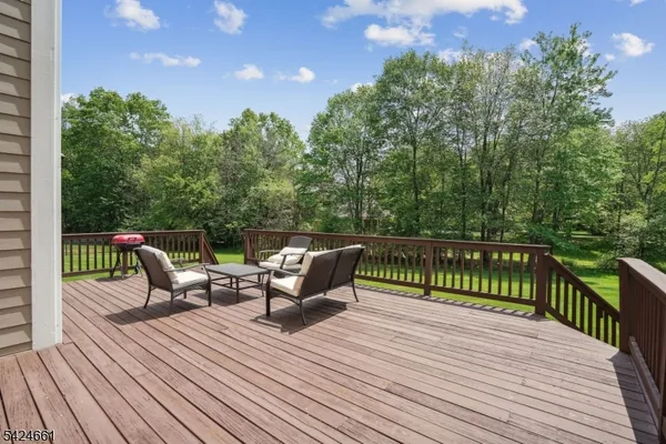 a balcony with wooden floor and furniture