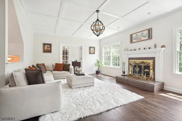 a living room with furniture a fireplace and wooden floor