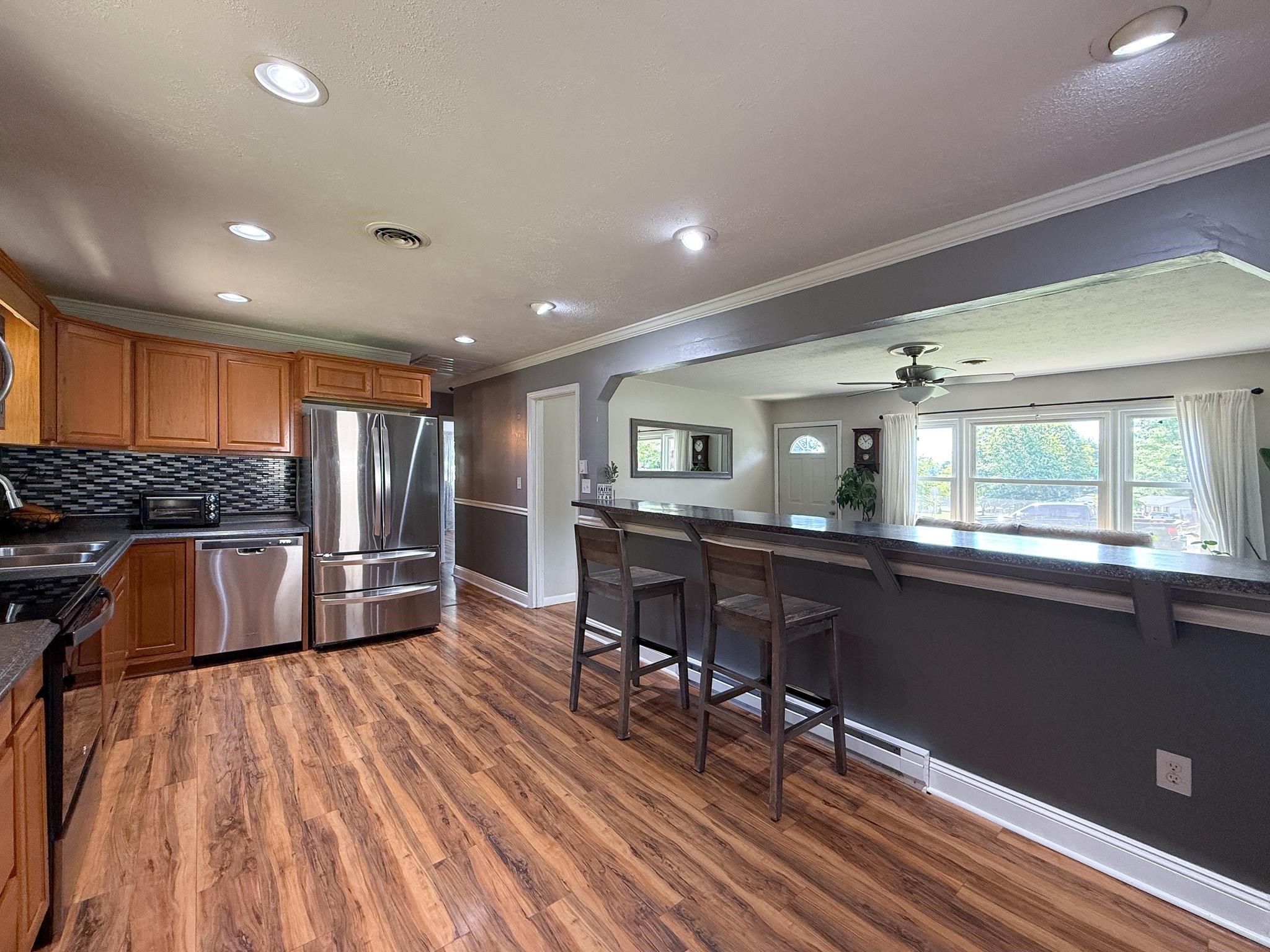 39 View Drive Stuarts Draft, VA 24477 - Photo 11 of 25 a kitchen with stainless steel appliances granite countertop a refrigerator a sink dishwasher a stove and white countertops with wooden floor