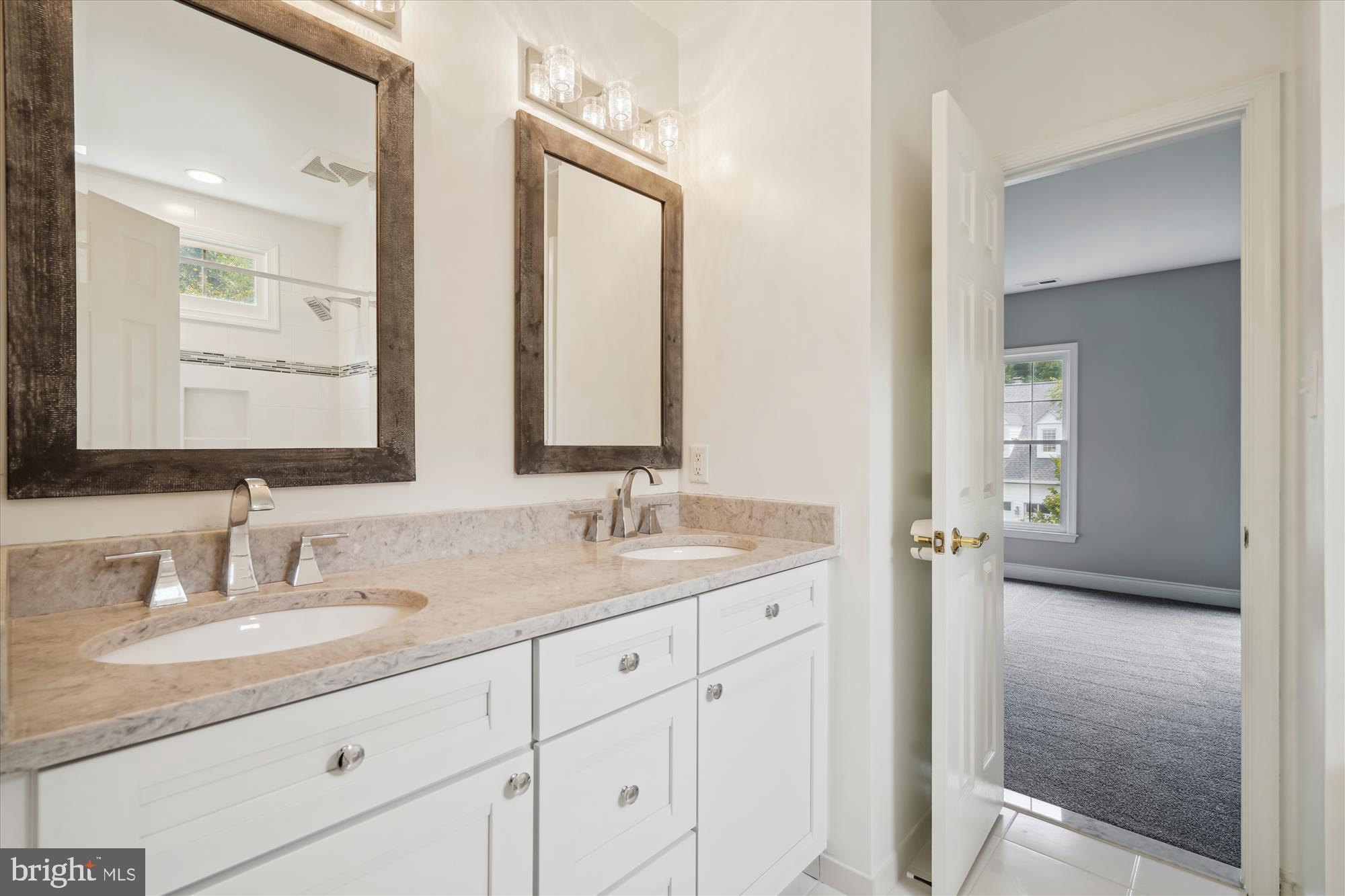 8757 Center Road Springfield, VA 22152 - Photo 15 of 21 a bathroom with a granite countertop sink double and mirror