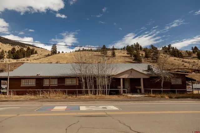 a front view of a house with a garden and parking space