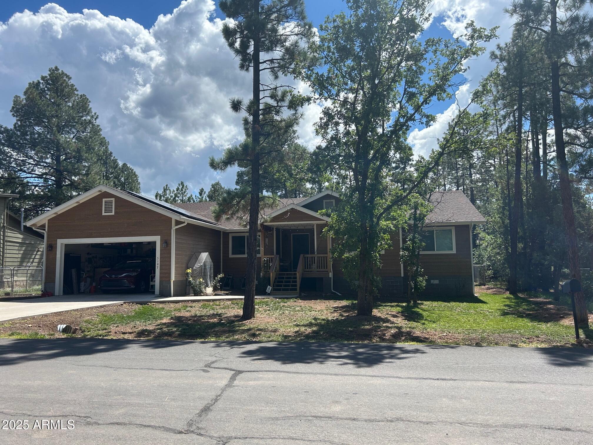 5107 Forest View Road Lakeside, AZ 85929 - Photo 23 of 24 a front view of a house with a yard and garage