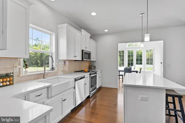 a kitchen with counter top space a sink cabinets and appliances