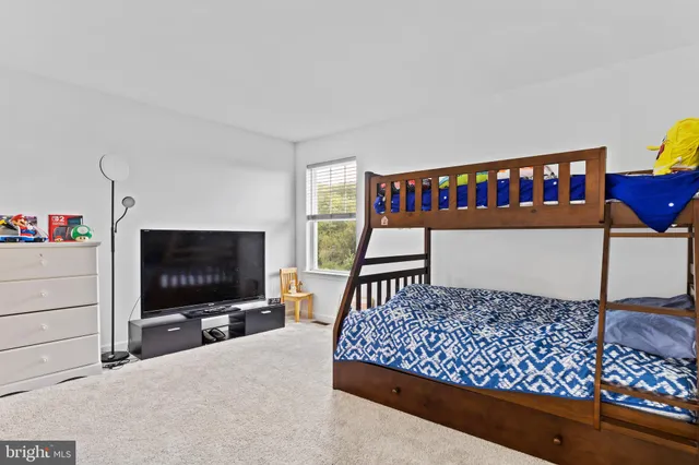 a bedroom with furniture and a flat screen tv