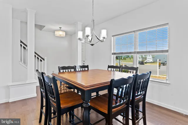 a dining room with a wooden table and chairs