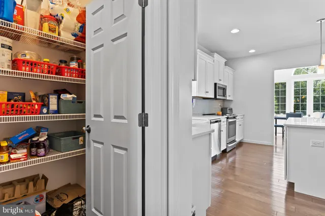a kitchen with stainless steel appliances a refrigerator and window