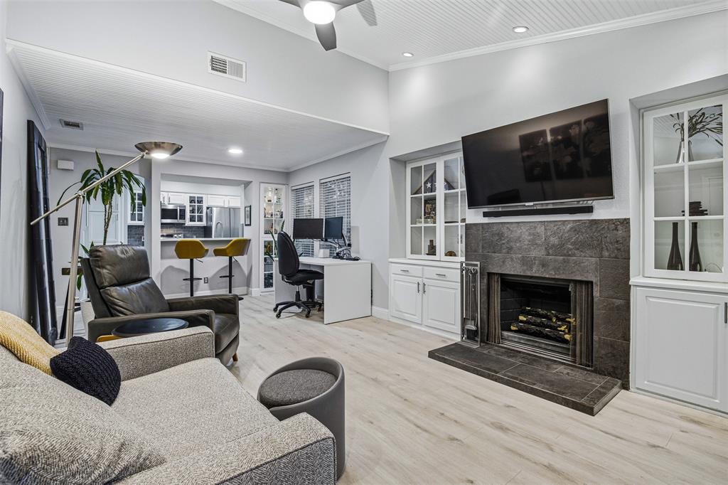 a living room with furniture fireplace and flat screen tv