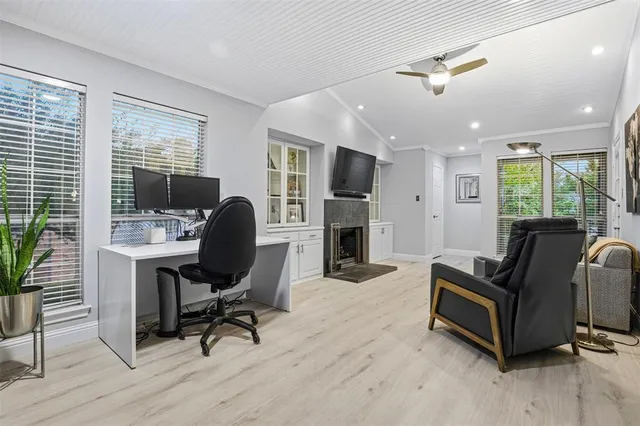 a view of a livingroom with workspace and a window