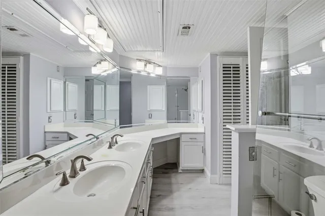 a bathroom with a sink double vanity and a mirror