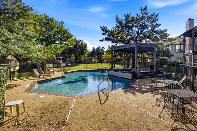 a view of a swimming pool with sitting area