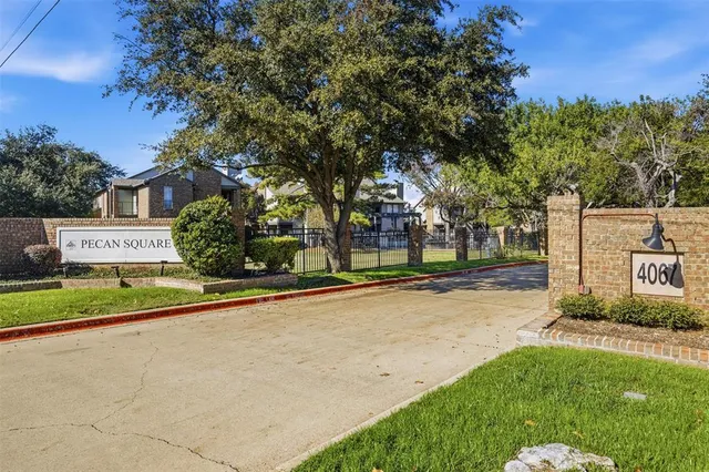 a view of a street with a building and a street sign