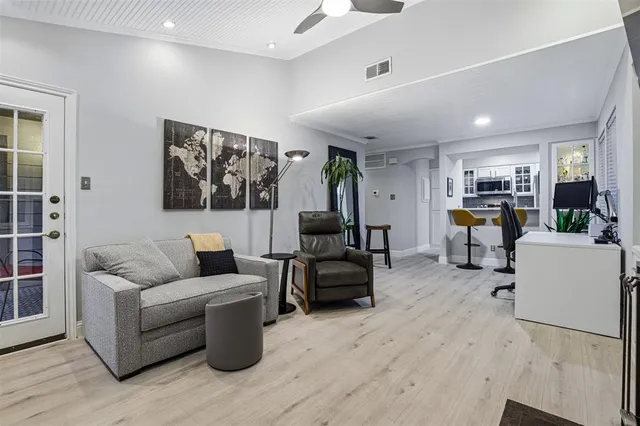 a living room with furniture and kitchen view