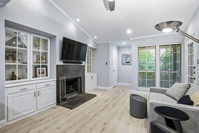 a living room with furniture a flat screen tv and a fireplace
