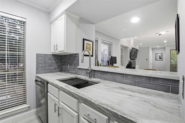 a kitchen with a sink and cabinets