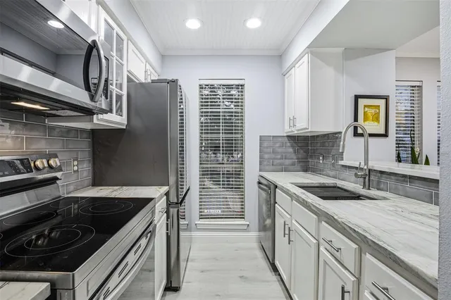 a kitchen that has a sink and a stove