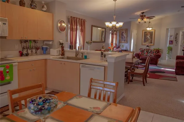 a kitchen with a sink and chairs