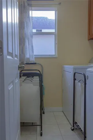 a utility room with closet dryer and washer