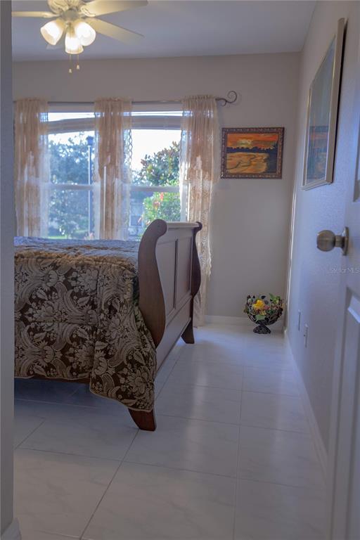 11241 Cocoa Beach Drive Riverview, FL 33569 - Photo 19 of 36 a bed sitting in a room next to a window