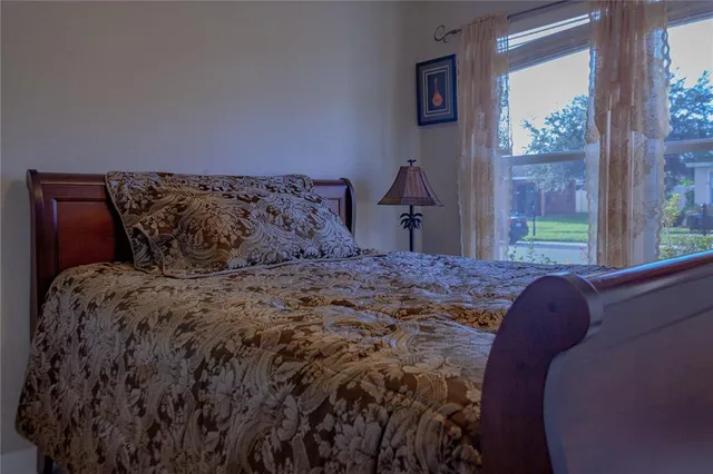 a bed sitting in a bedroom next to a window