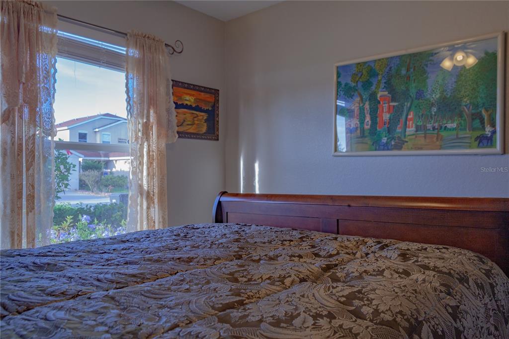 11241 Cocoa Beach Drive Riverview, FL 33569 - Photo 21 of 36 a bed sitting in a bedroom next to a window