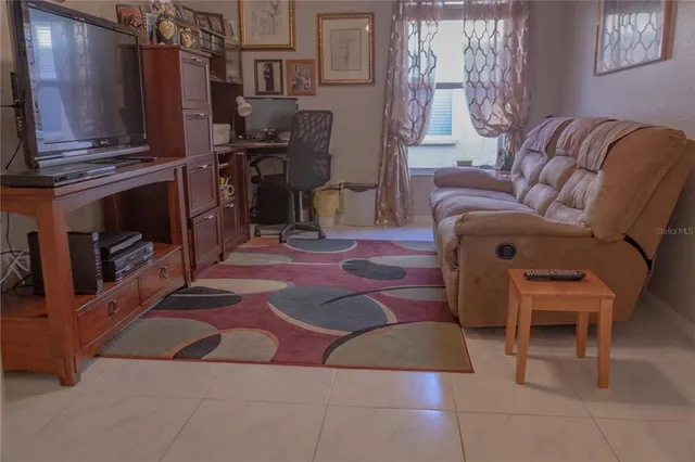 a room with furniture and screen flat screen tv