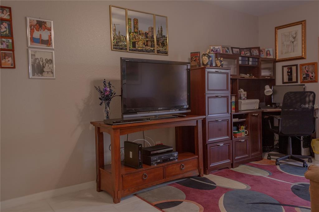 11241 Cocoa Beach Drive Riverview, FL 33569 - Photo 24 of 36 a room with furniture and screen flat screen tv