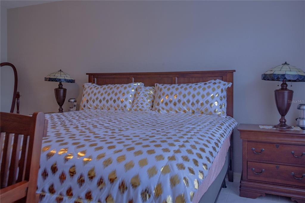 11241 Cocoa Beach Drive Riverview, FL 33569 - Photo 33 of 36 a bedroom with a bed and wooden floor