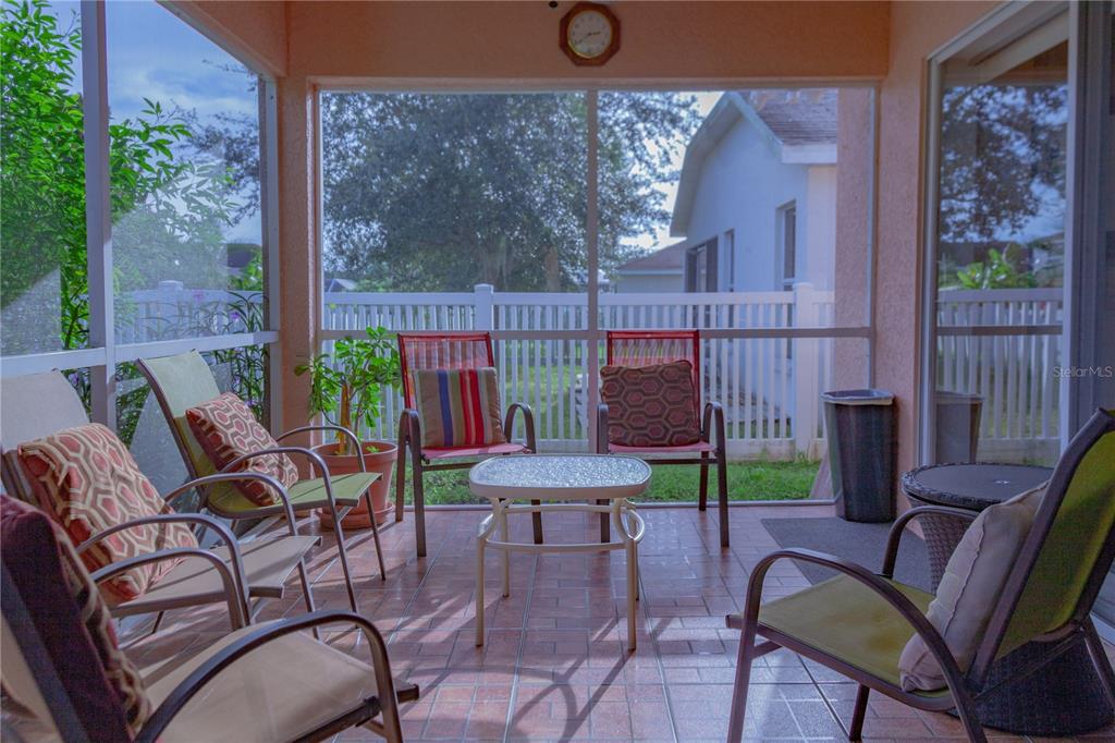 11241 Cocoa Beach Drive Riverview, FL 33569 - Photo 35 of 36 a balcony with chairs and a potted plant
