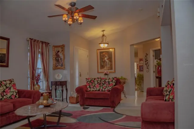 a living room with furniture and a chandelier