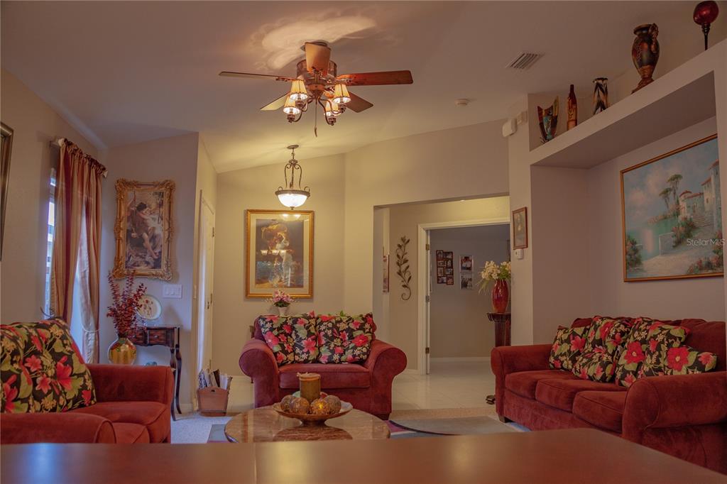11241 Cocoa Beach Drive Riverview, FL 33569 - Photo 7 of 36 a living room with furniture and a chandelier