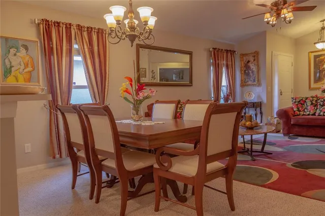 a view of a dining room with furniture and a chandelier