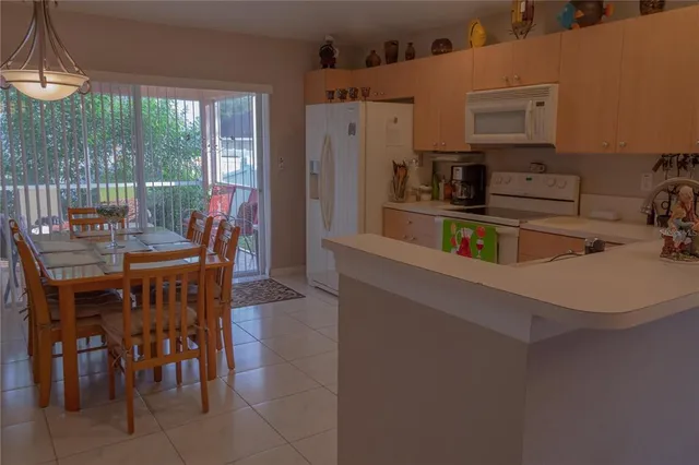 a kitchen with stainless steel appliances a table and chairs