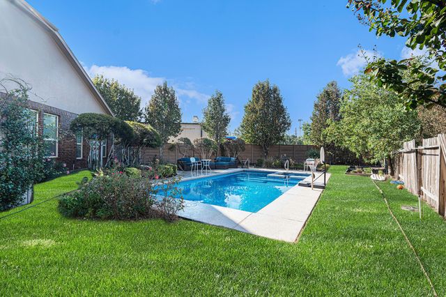 a view of a backyard with swimming pool