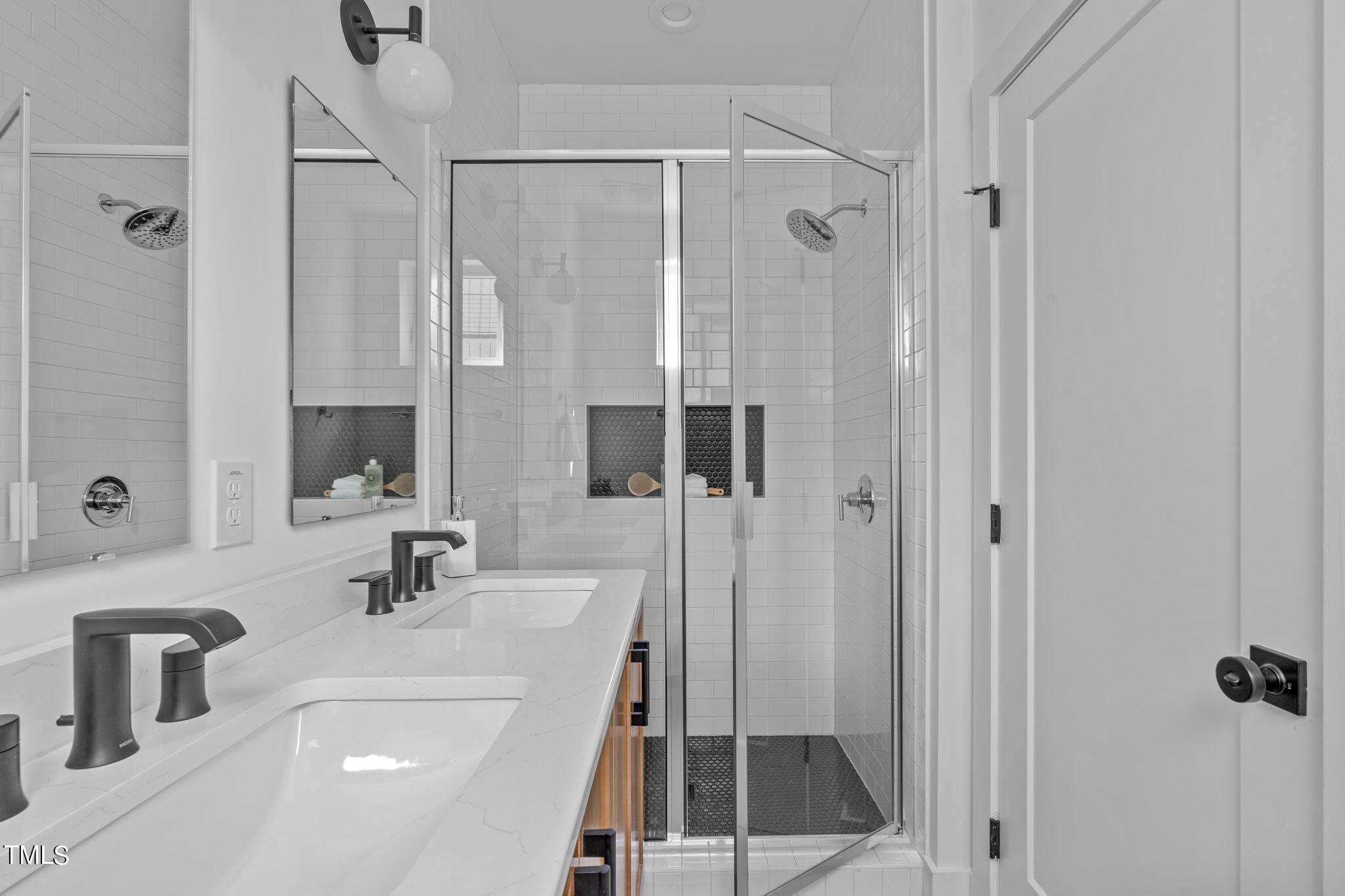 3003 Corbell Durham, NC 27701 - Photo 17 of 26 a bathroom with a shower sink and mirror