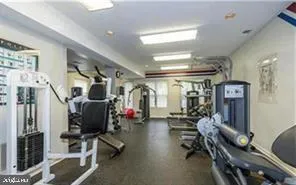 a room with gym equipment and a large window