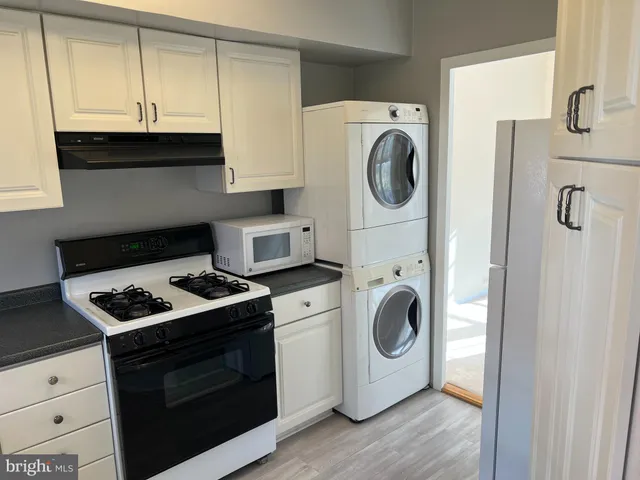 a kitchen with a stove and a washing machine