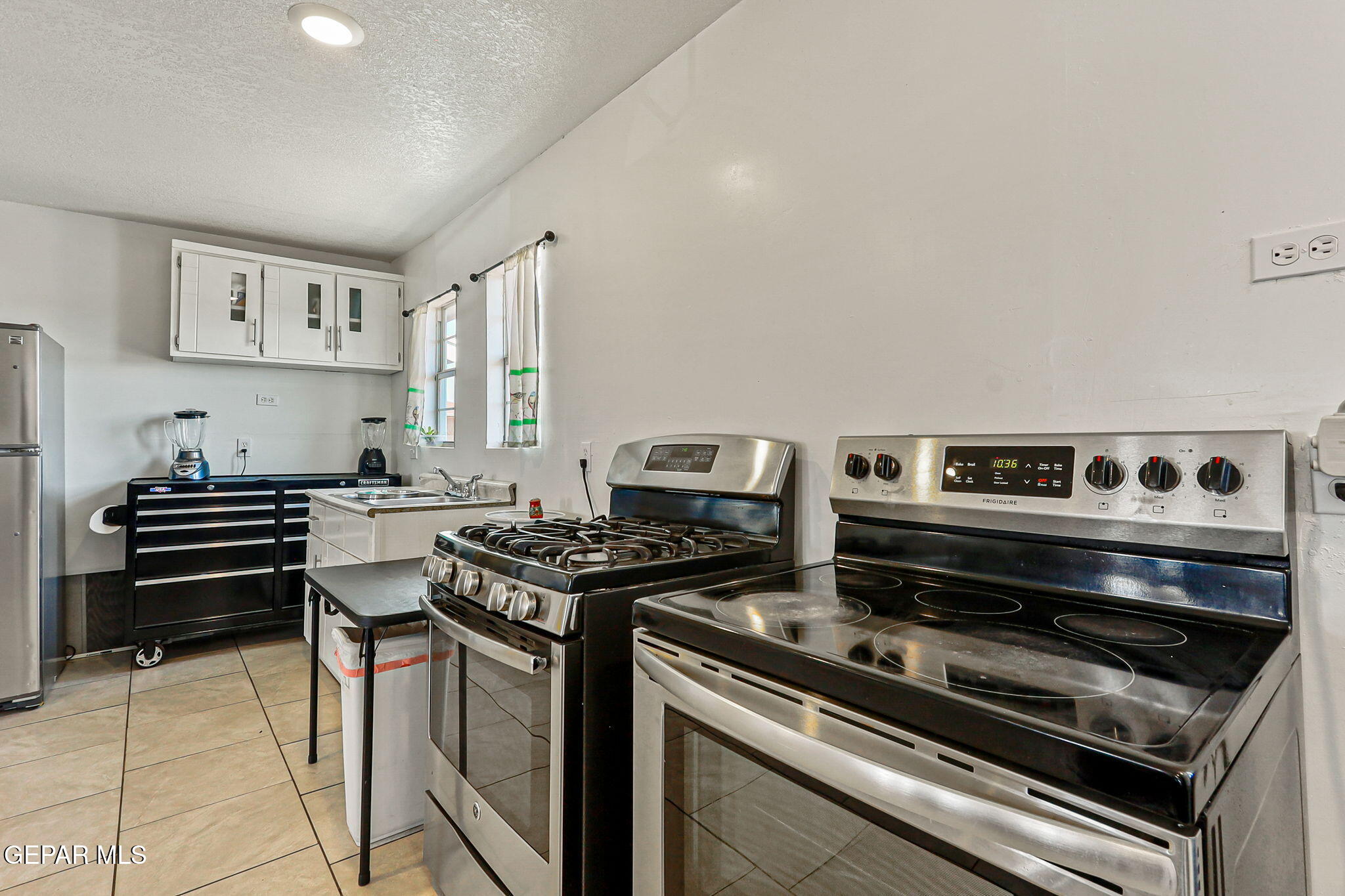 13419 Mendoza Road San Elizario, TX 79849 - Photo 14 of 55 a stove top oven sitting inside of a kitchen