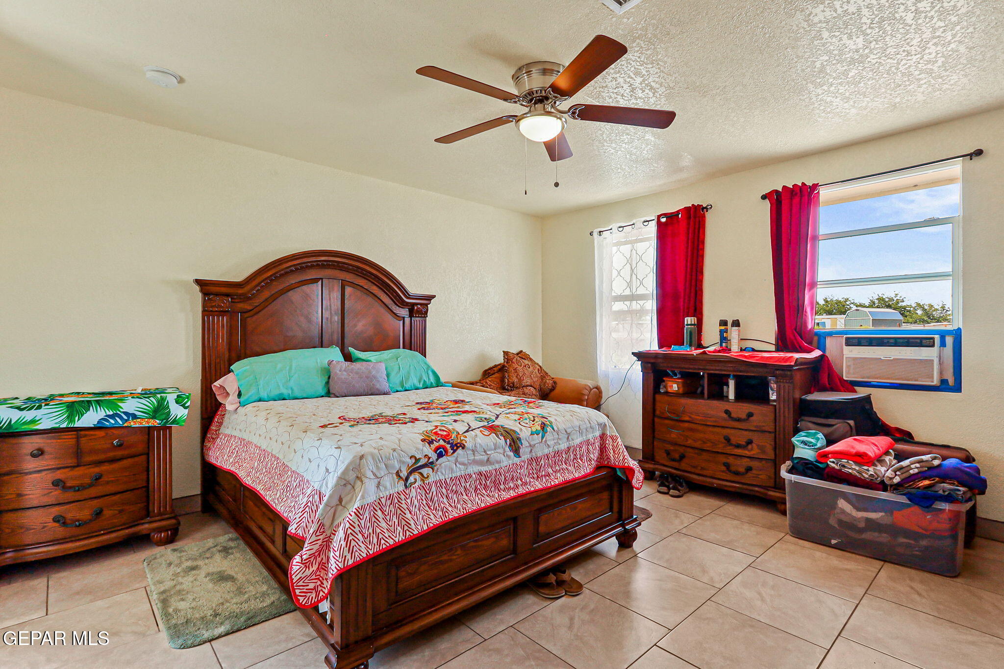 13419 Mendoza Road San Elizario, TX 79849 - Photo 17 of 55 a bedroom with a bed and a chandelier