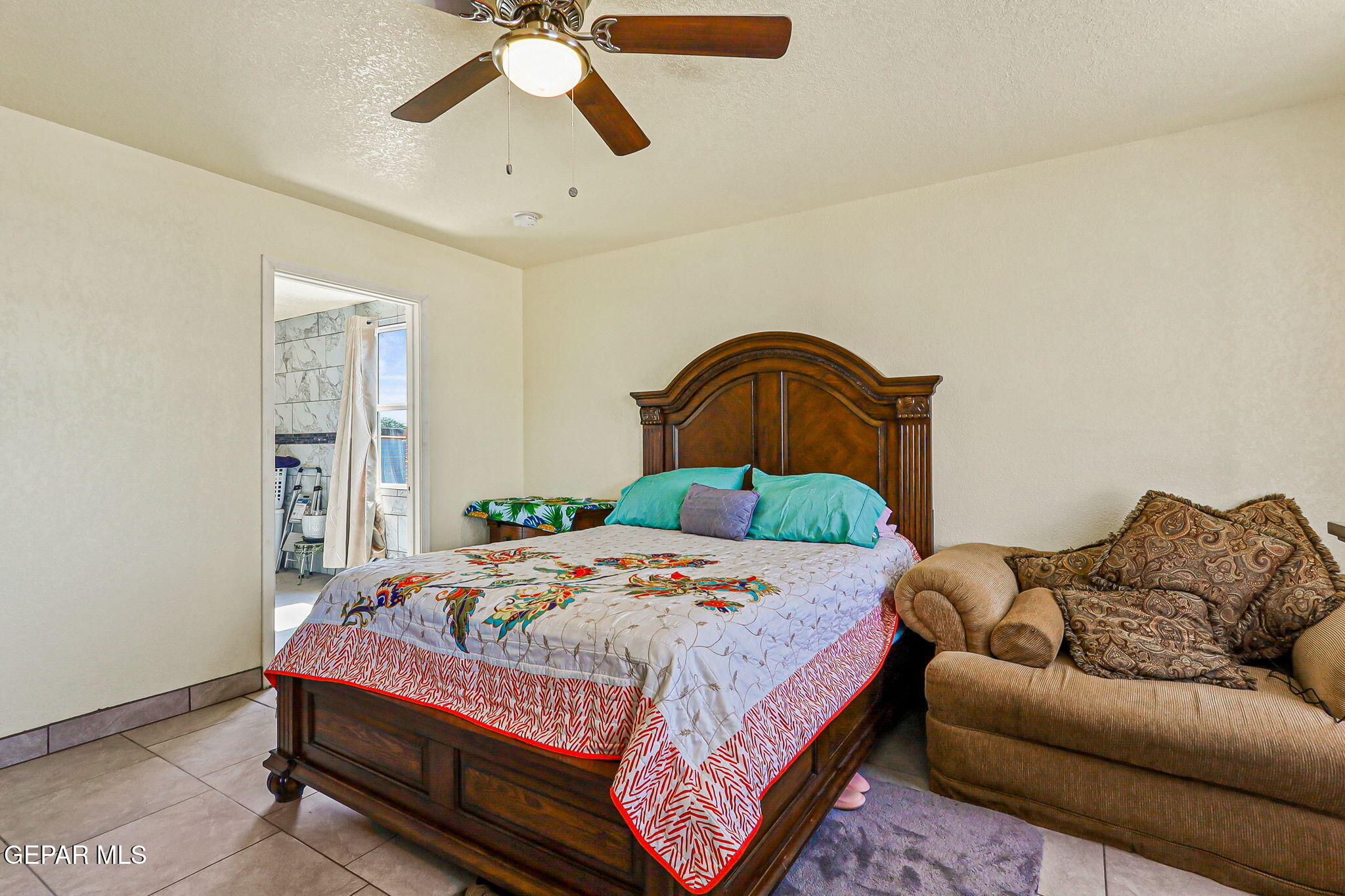 13419 Mendoza Road San Elizario, TX 79849 - Photo 18 of 55 a bedroom with a bed couch and window