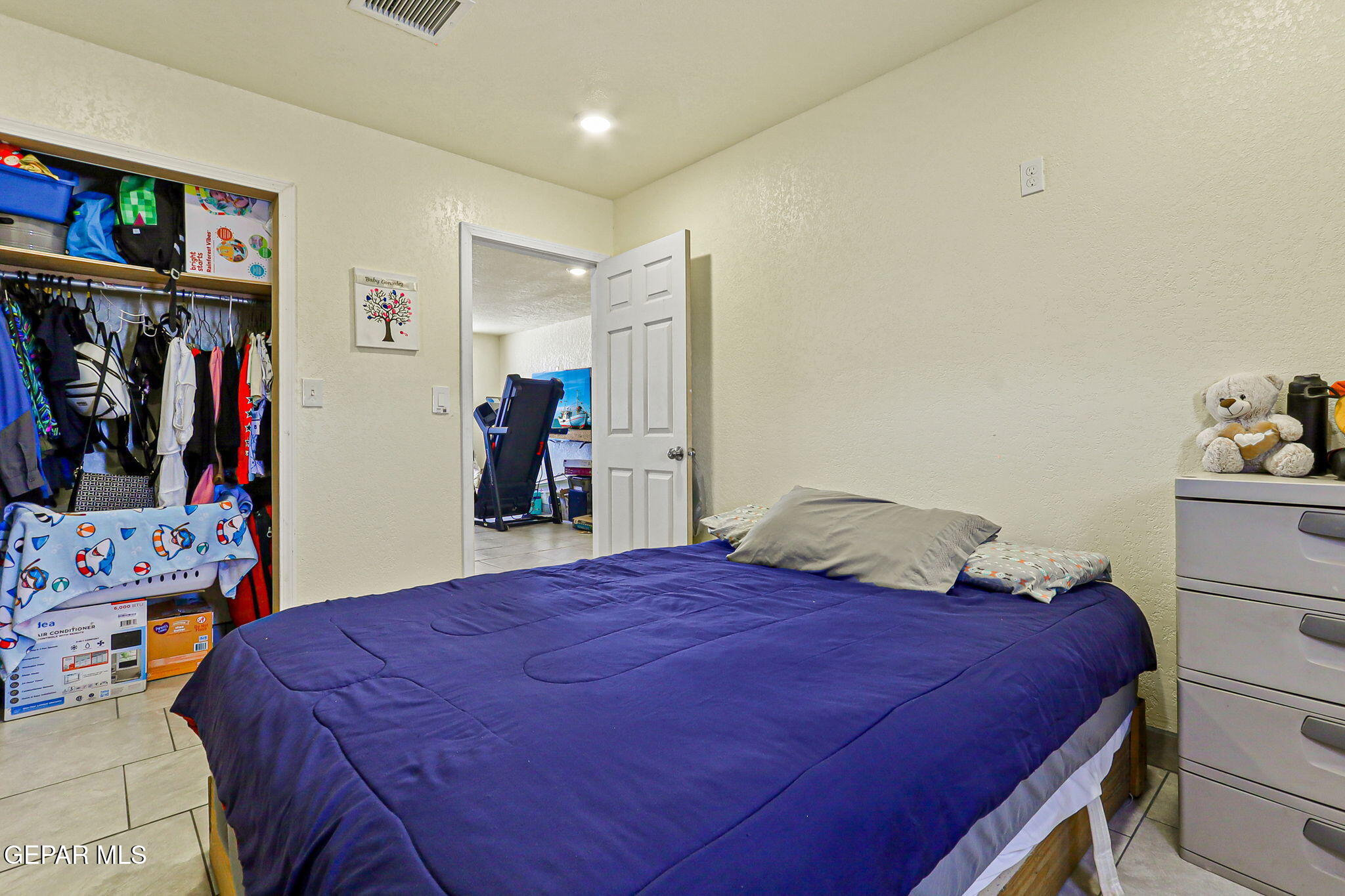 13419 Mendoza Road San Elizario, TX 79849 - Photo 23 of 55 a bedroom with a bed and a walk in closet