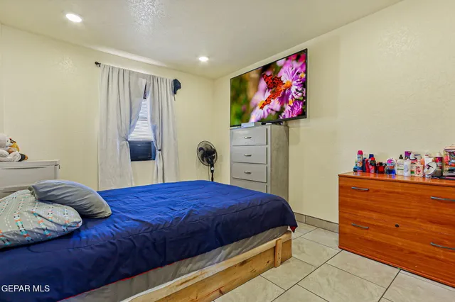 a bedroom with a bed and a dresser