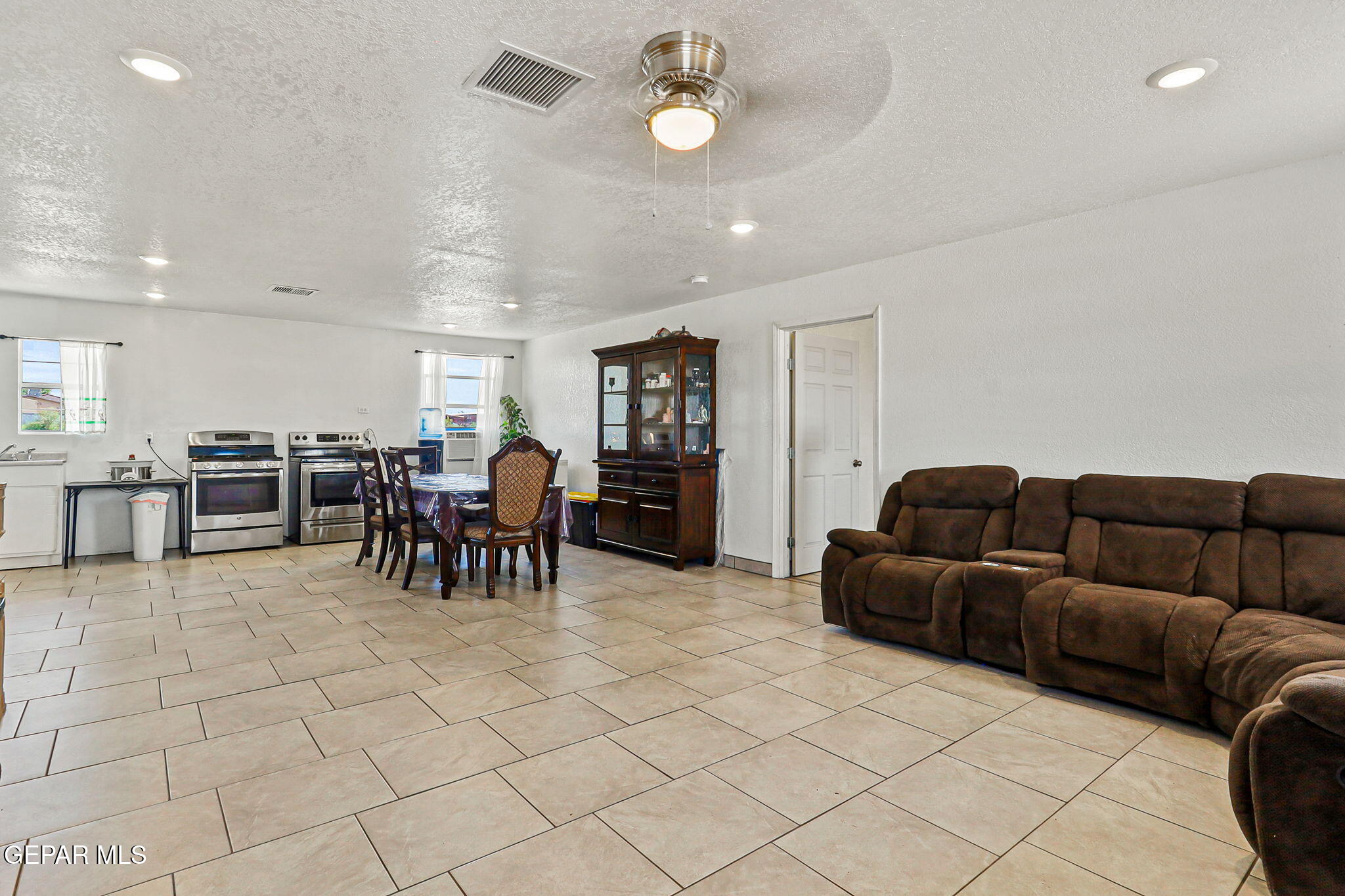 13419 Mendoza Road San Elizario, TX 79849 - Photo 3 of 55 a living room with furniture and kitchen view