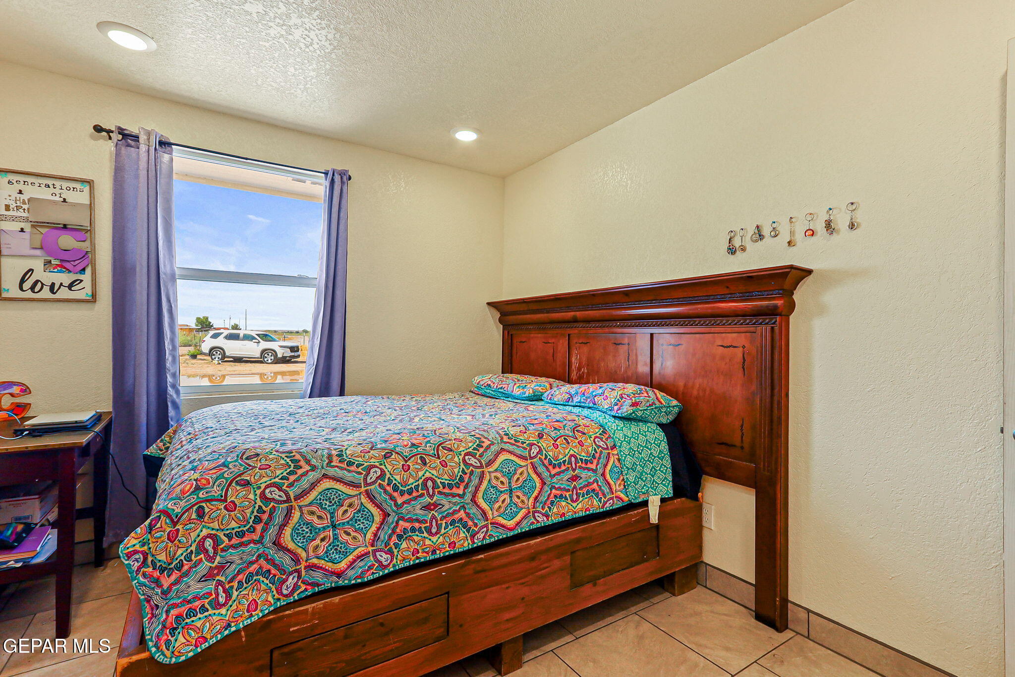 13419 Mendoza Road San Elizario, TX 79849 - Photo 31 of 55 a bedroom with a bed and dresser